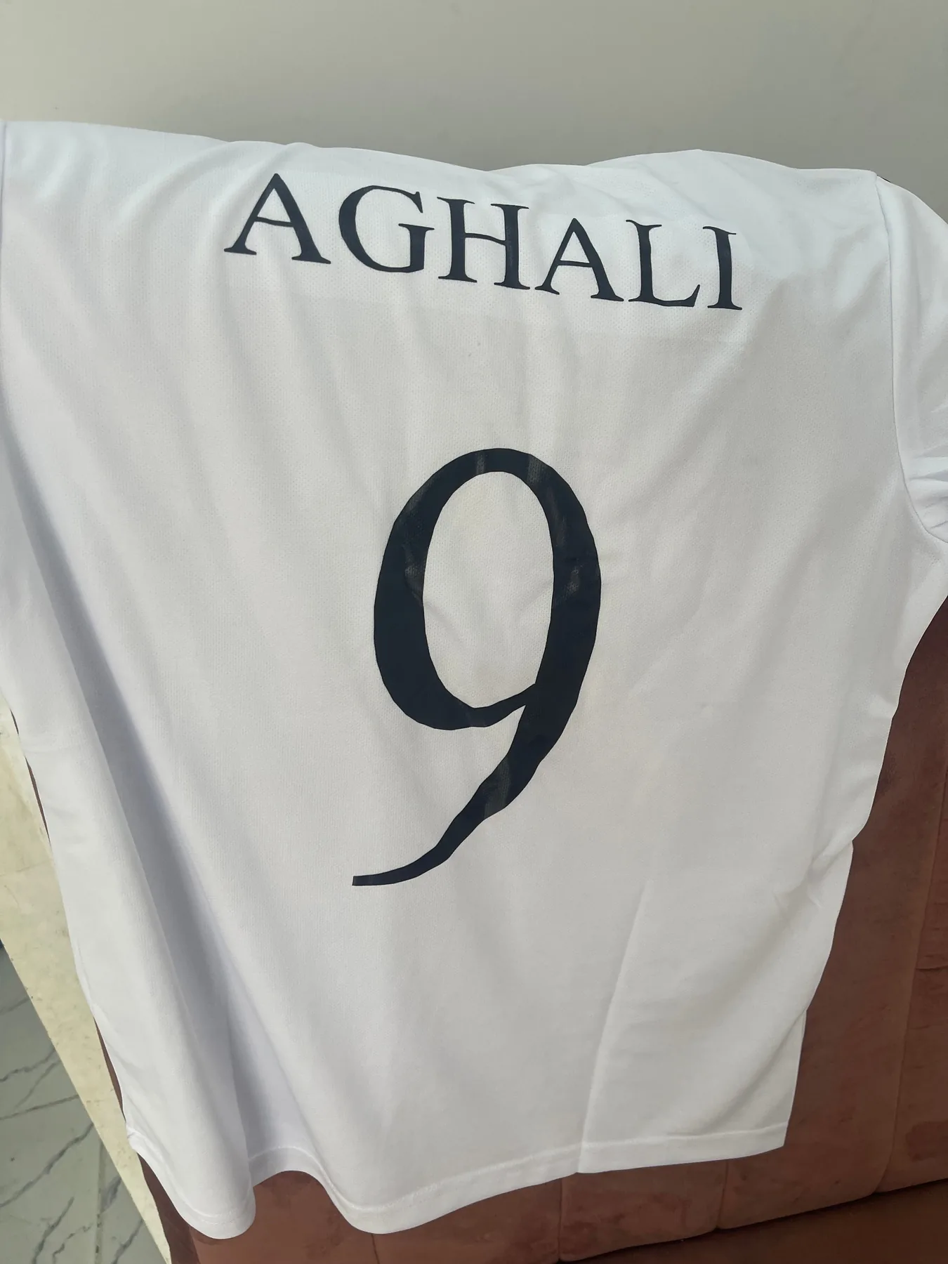 White customized T-shirt with a name and number